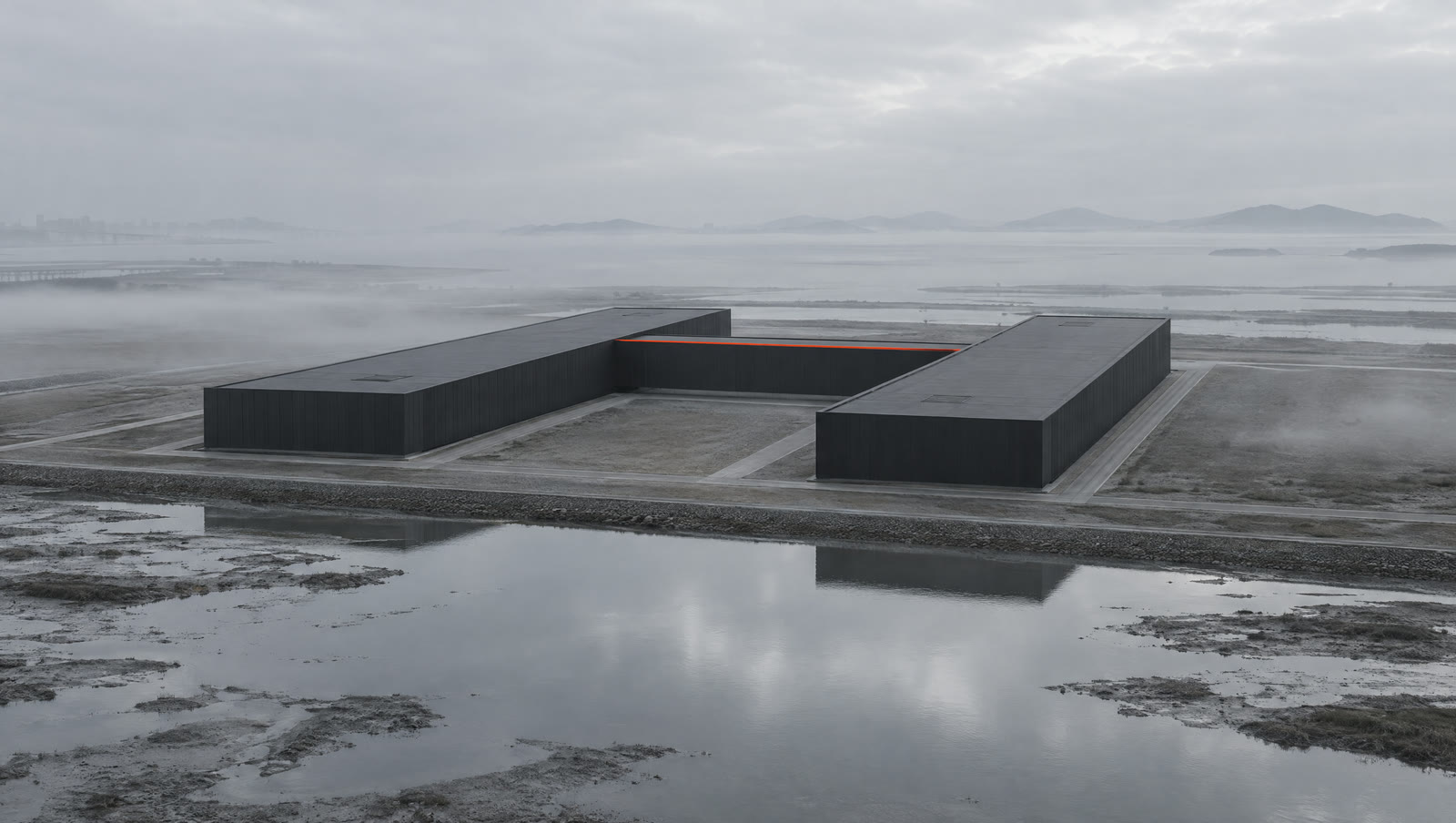 Concept visualization of two data halls joined by a central block on flat land at dawn